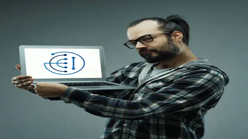 Hombre con barba que sostiene un portátil con un logotipo azul
